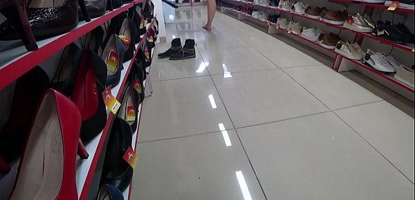  Voyeur and foot fetish in a public place. Beautiful legs in stockings and a juicy ass under a short dress in a shoe store.